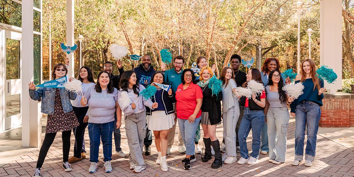 Students outside waving AACC promo items